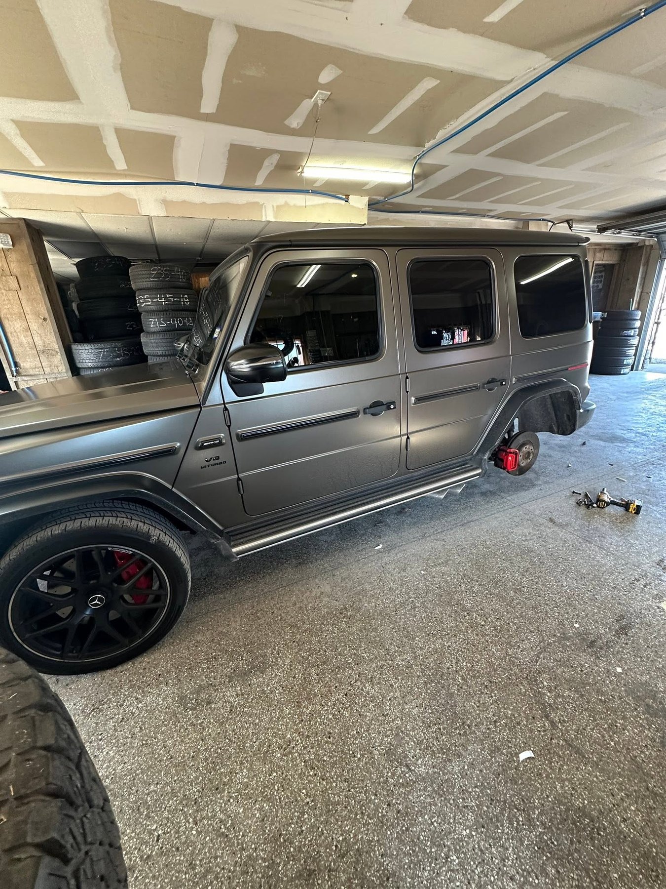 Mercedes-AMG G-Wagon up on the jack in the Beristain's service bay